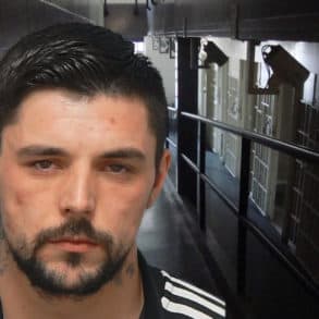 Mugshot of Connor Barnes with jail corridor in background