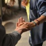 man touching a woman's hand