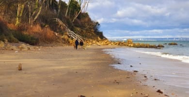 two people with a dog walking along Priory Bay beach - IW Ramblers