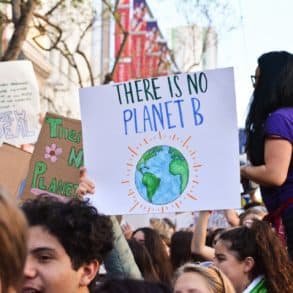 Climate change campaigners on march with banner reading there is no planet B
