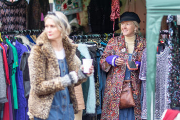 Lucy Whelan and partner at vintage emporium stall by Julian Winslow