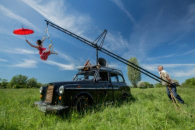 Performers for Pirate Taxi, showing woman being suspended over a taxi