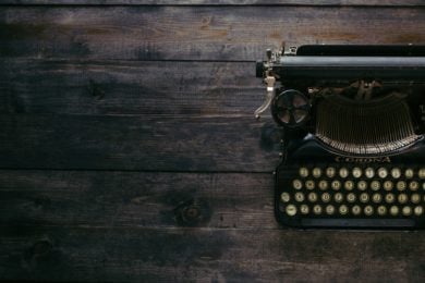 black corona typewriter on wooden tabletop