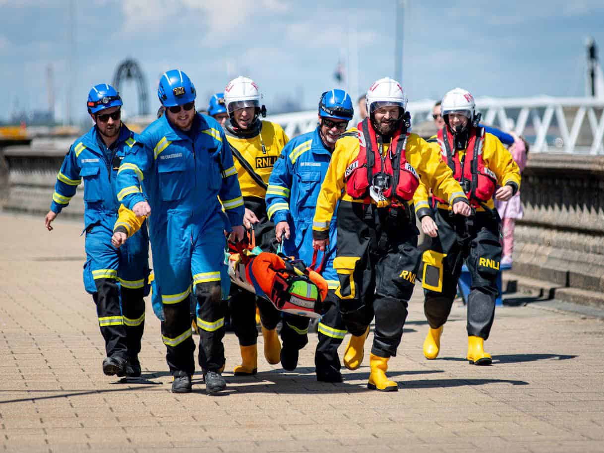 Crew and coastguards carrying a 'casualty' along The Parade