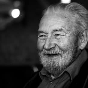 Black and white photo of older man smiling