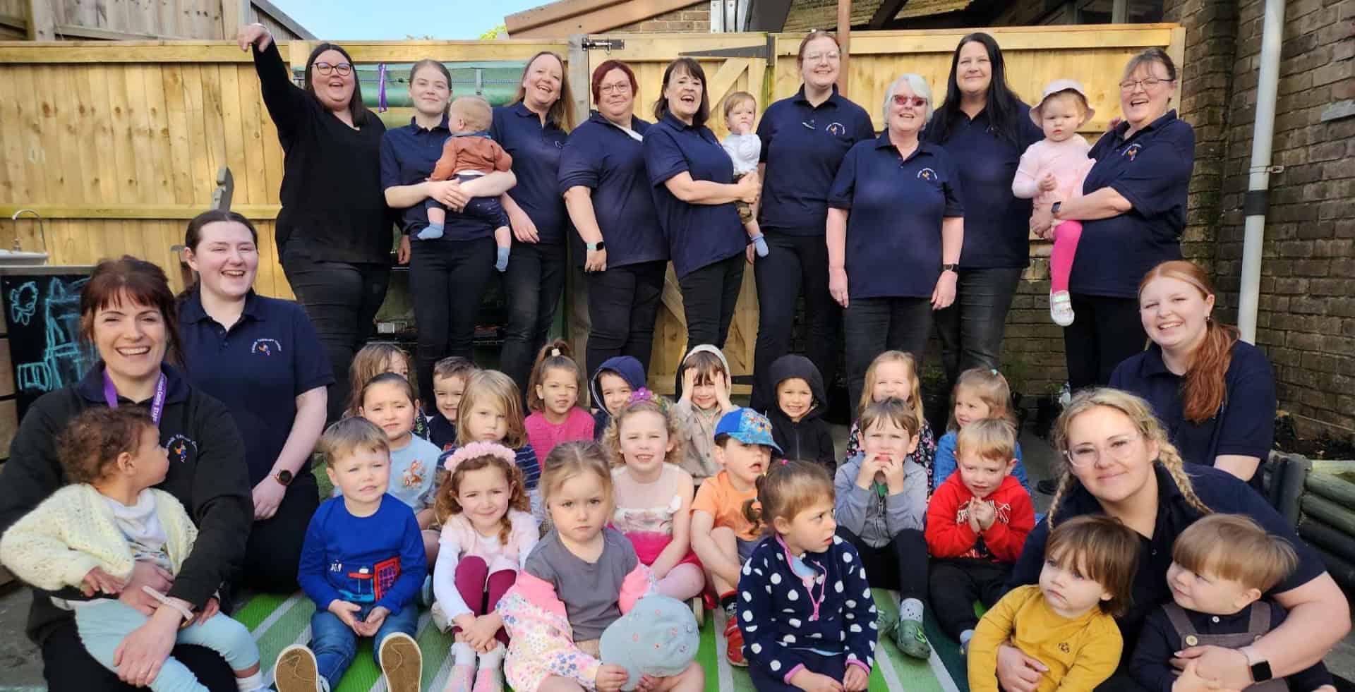 Staff and children at Furzehill Childcare Centre