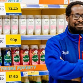 Tesco staff member standing by hygiene products