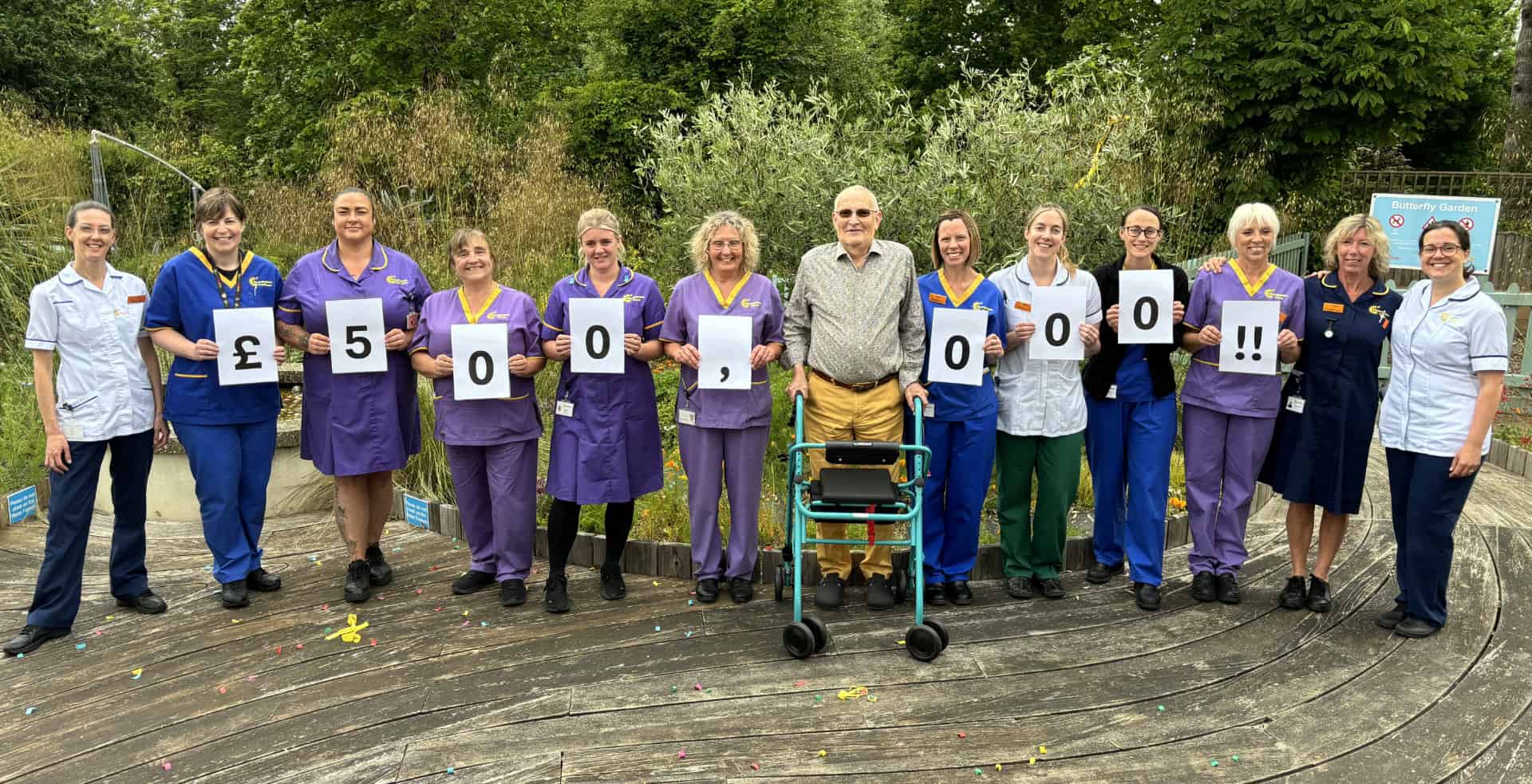 Members of mountbatten staff holding cards showing Walk the Wight fundraising Milestone