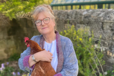 Miranda Acland with a chicken