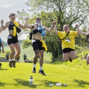 Walkers jumping in the air as part of Walk the Wight 2024