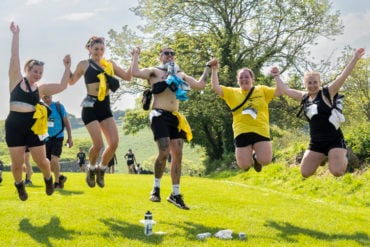 Walkers jumping in the air as part of Walk the Wight 2024