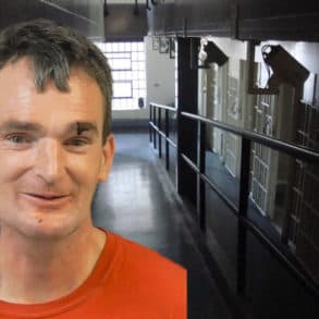 Mugshot of David Dunford with jail corridor in background