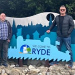 Councillors Malcolm Ross, Simon Cooke and Ian Dore standing by the 'welcome to Ryde sign'