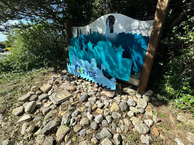 The 'welcome to Ryde sign' hidden by overgrowth