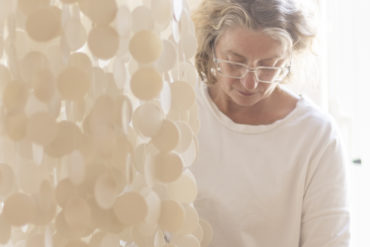 installation of Two Thousand porcelain discs hanging in the chapel at Mountbatten's Hospice, with sue paraskeva