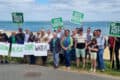 Green Party members with candidates and Baroness Jenny Jones on seafront holding banners