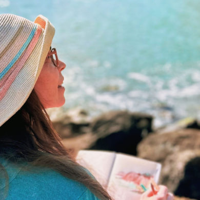 Lucia Para sitting by beach painting