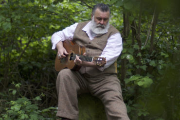 PAUL Armfield sitting among the trees with his guitar - Alice Armfield