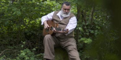 PAUL Armfield sitting among the trees with his guitar - Alice Armfield