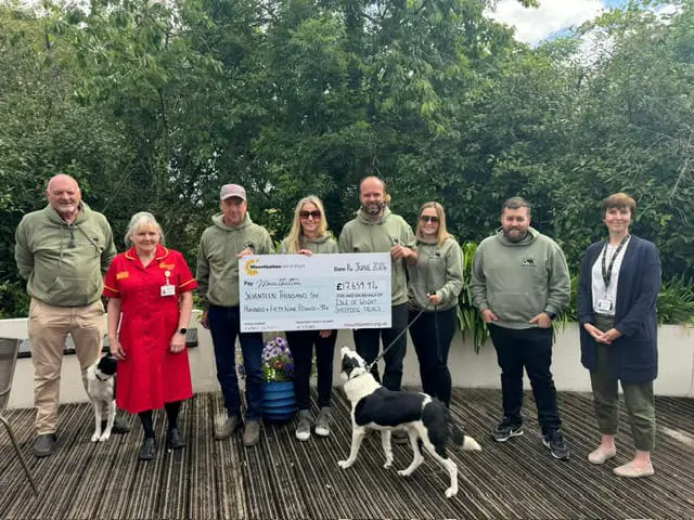 Sheepdog trials committee presenting giant cheque to Mountbatten staff