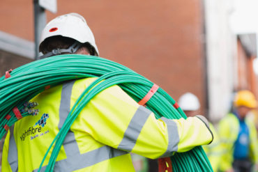 WightFibre operative with rolls of cables on his shoulder