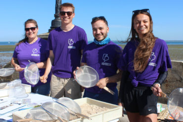 Portsmouth Uni staff by the beach with sieves