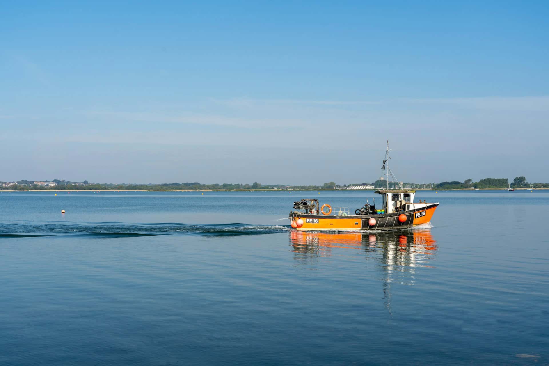 a fishing boat on still waters