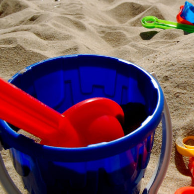 bucket and spade on sandy beach