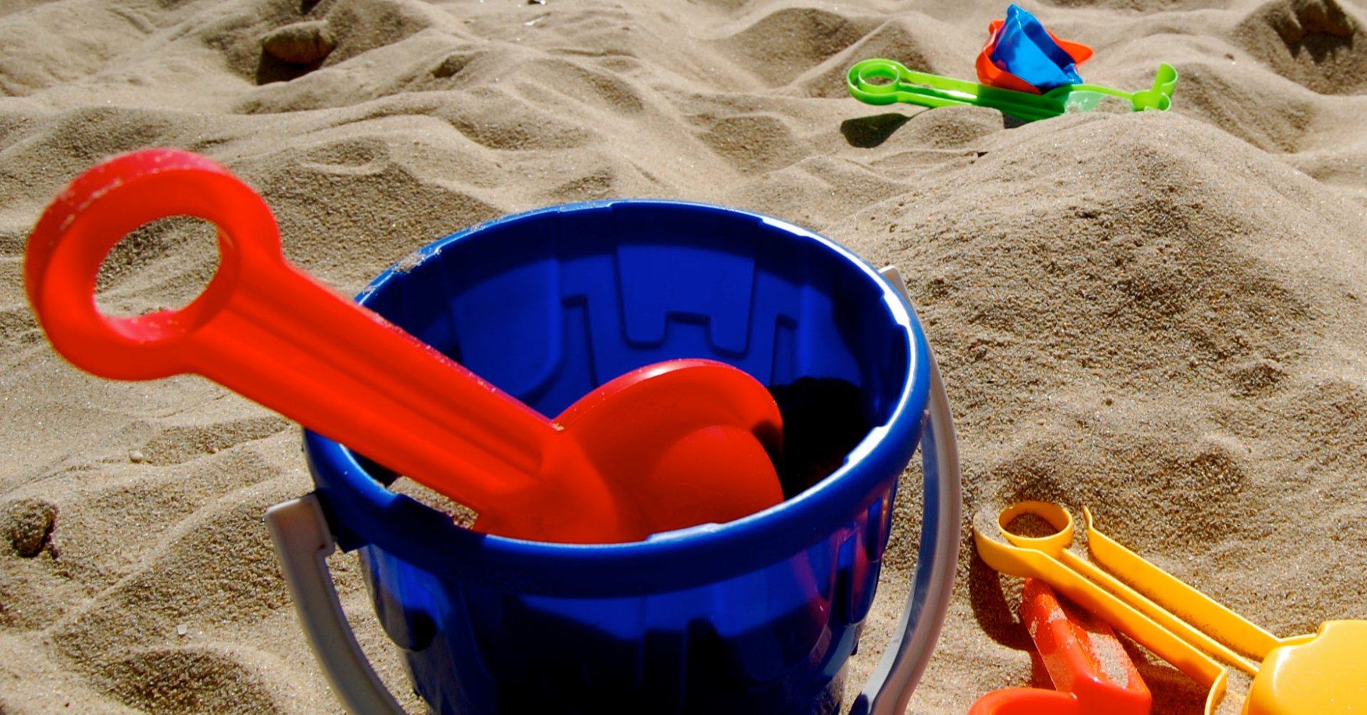 bucket and spade on sandy beach