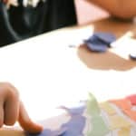 child getting crafty with paper