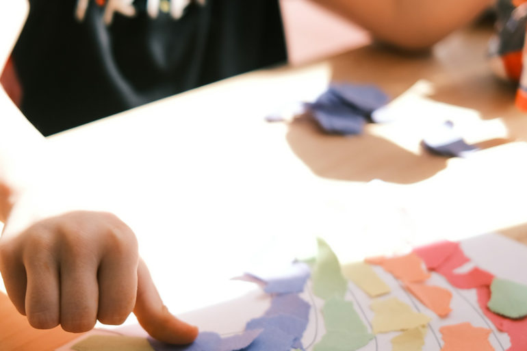 child getting crafty with paper