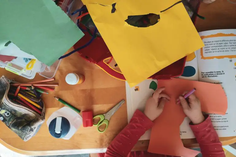 children cutting out coloured paper