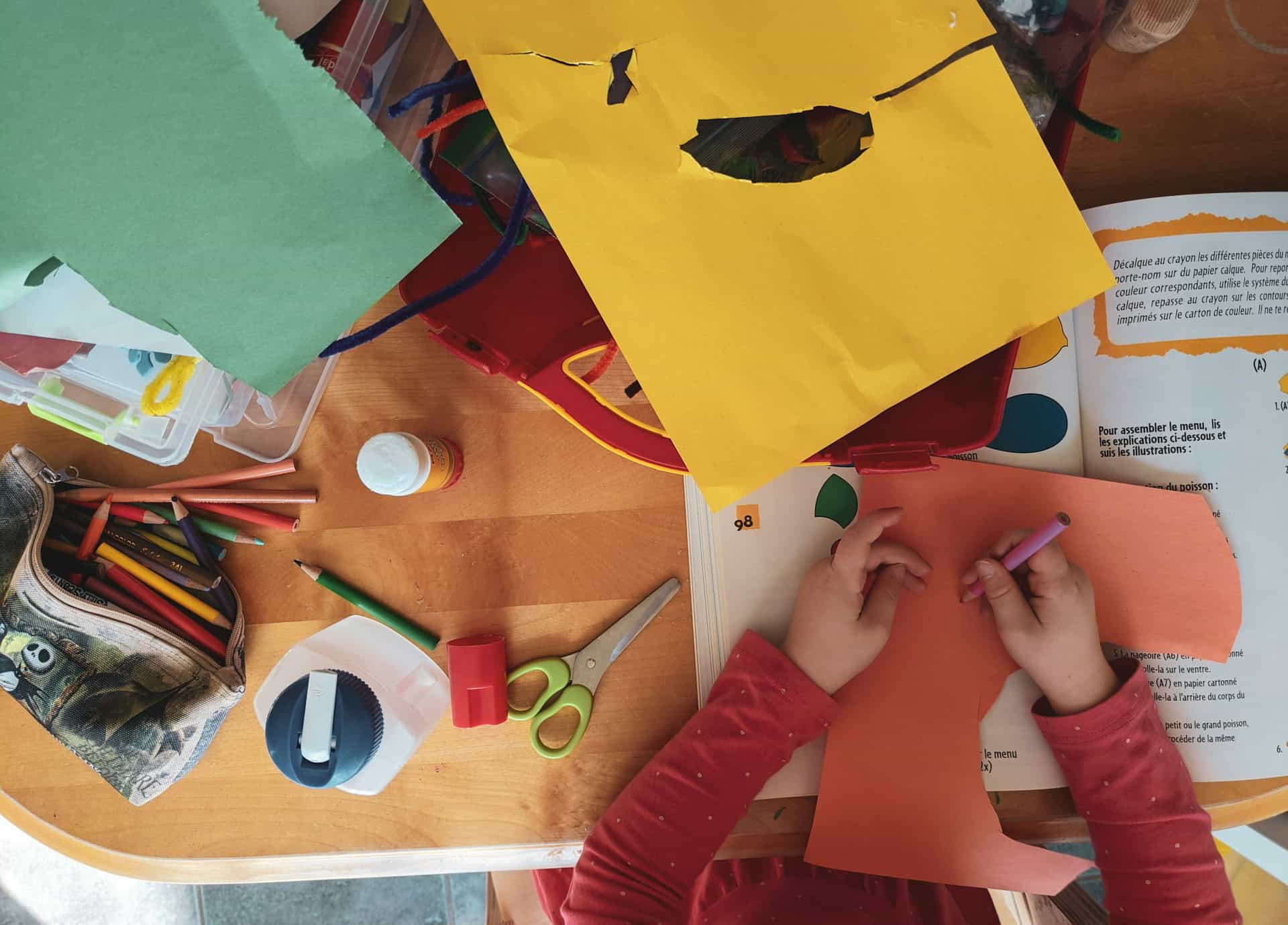 children cutting out coloured paper