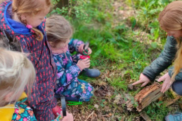 Children exploring woodland as part of forest school