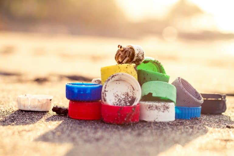 plastic lids on a beach