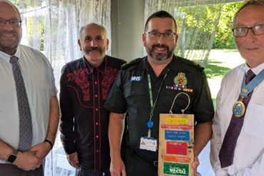 Simon Moye from Southern Vectis and Graham Biss High Sheriff presenting the award to Steve and Simon