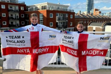 Anya and Kenzie with flags