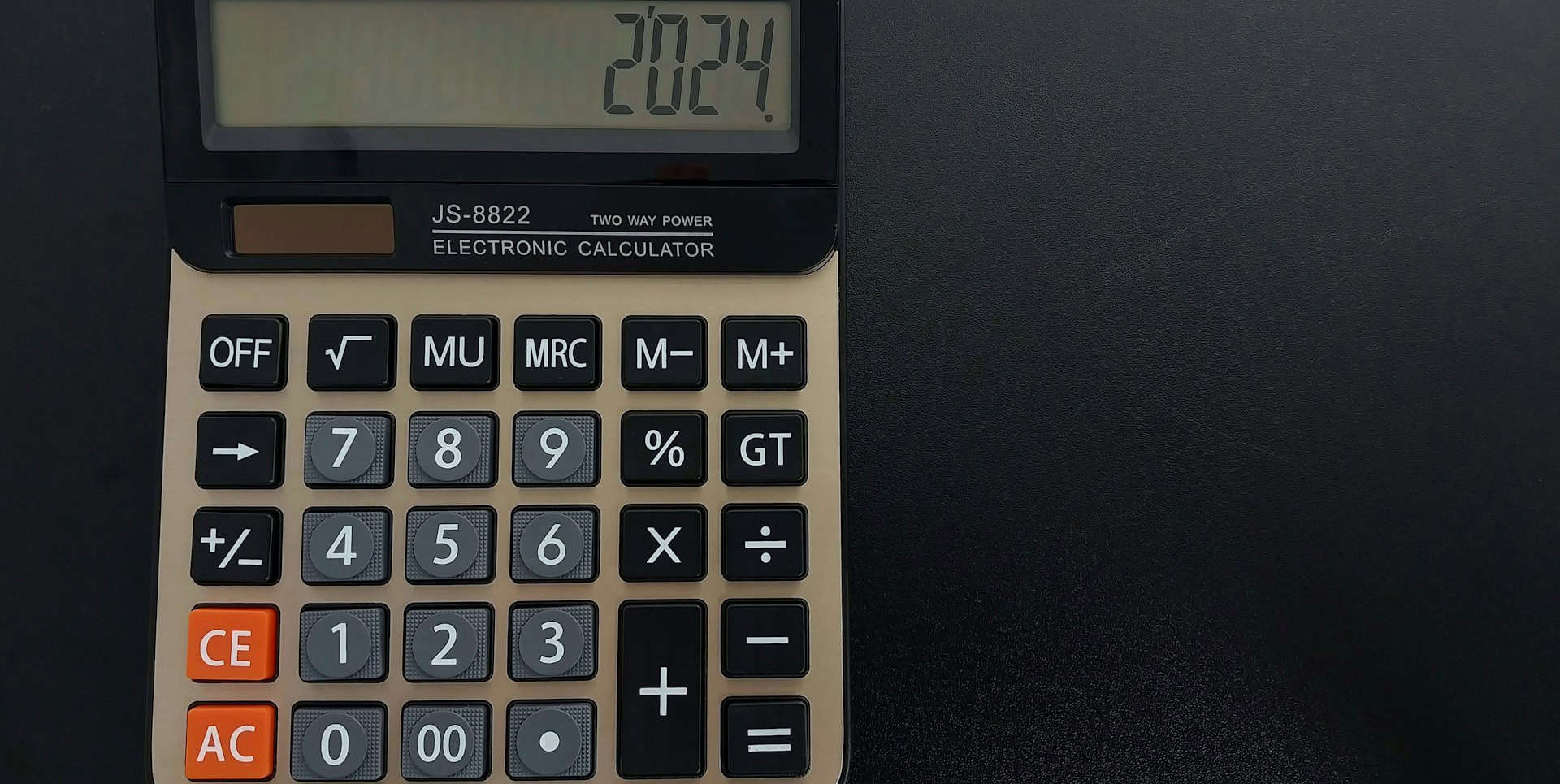 Desk calculator on dark background