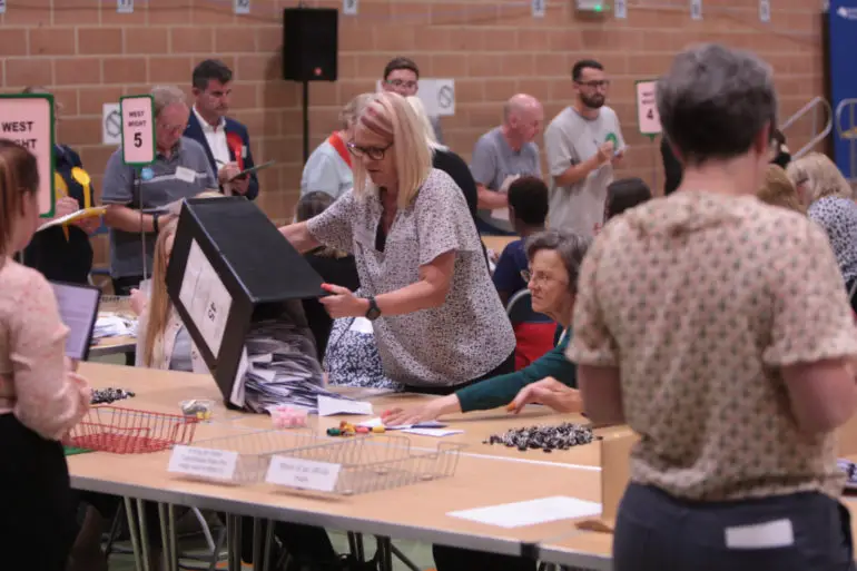 People sorting West wight ballot papers at general election count