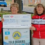 Jan Brookes from Isle Access receiving cheque from Vic Mann and Hilary Searle