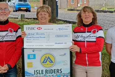 Jan Brookes from Isle Access receiving cheque from Vic Mann and Hilary Searle
