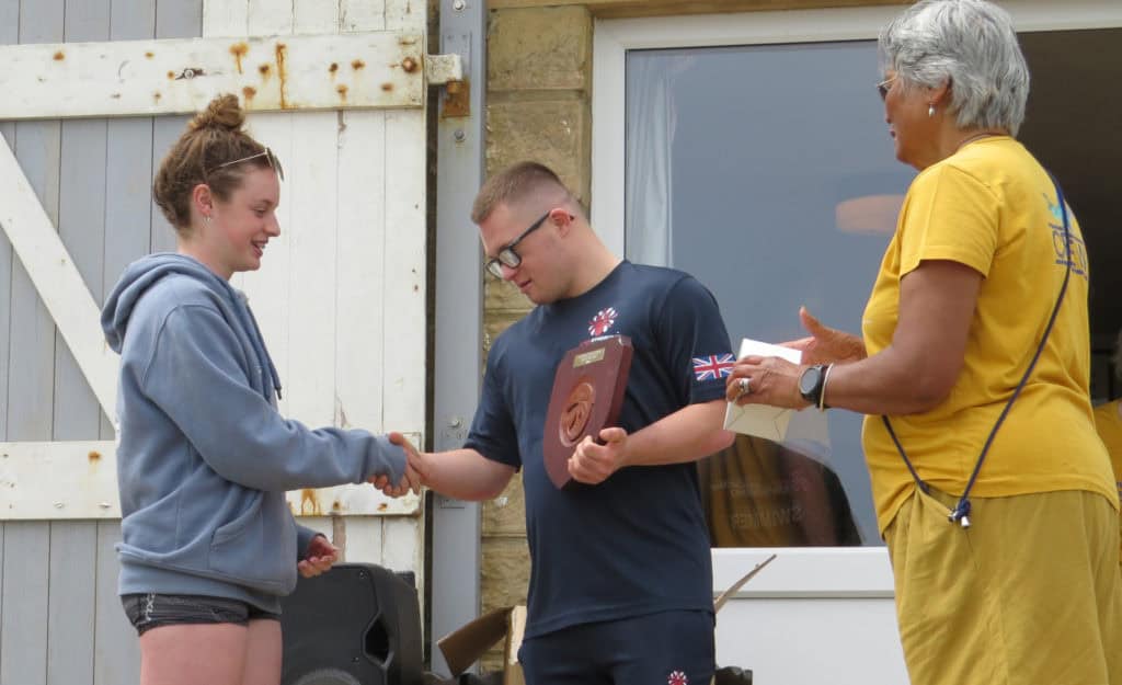 Zav being awarded his trophy after the Pier to Pier swim 2024