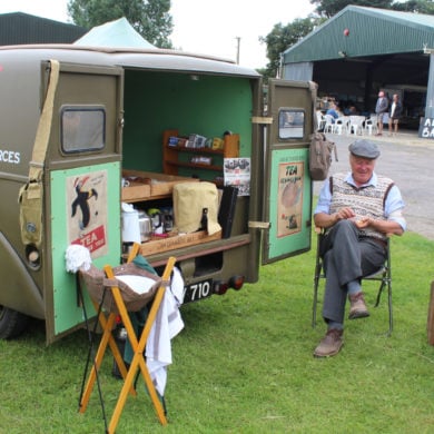 Vehicle on display and people in 40s gear