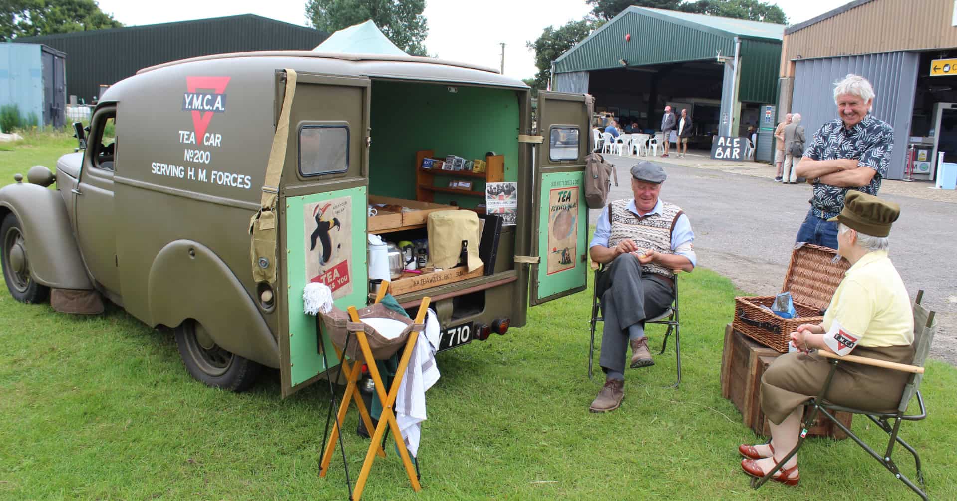 Vehicle on display and people in 40s gear