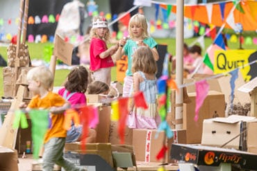 Children surrounded by cardboard in the park