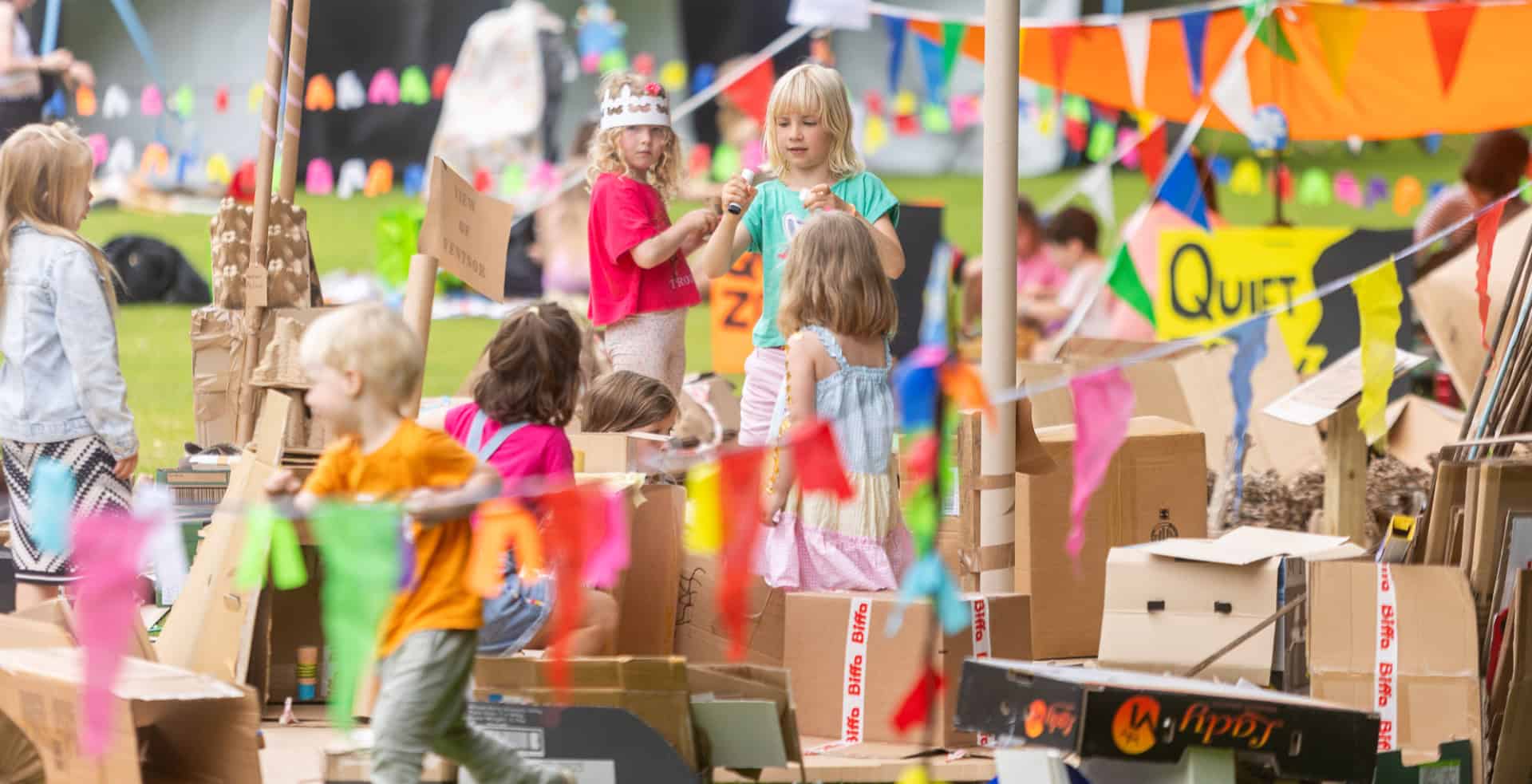 Children surrounded by cardboard in the park