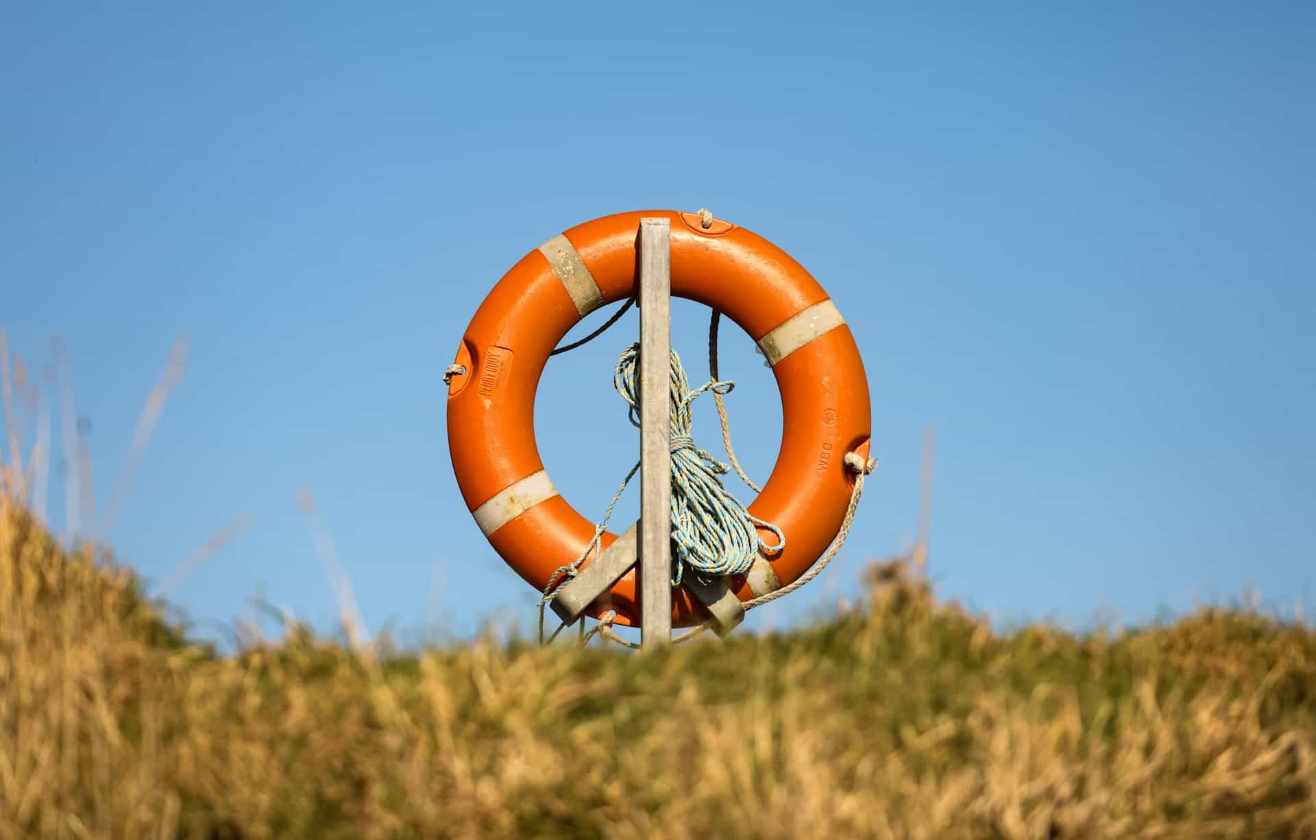 Life saver ring by the coast, with blue sky background