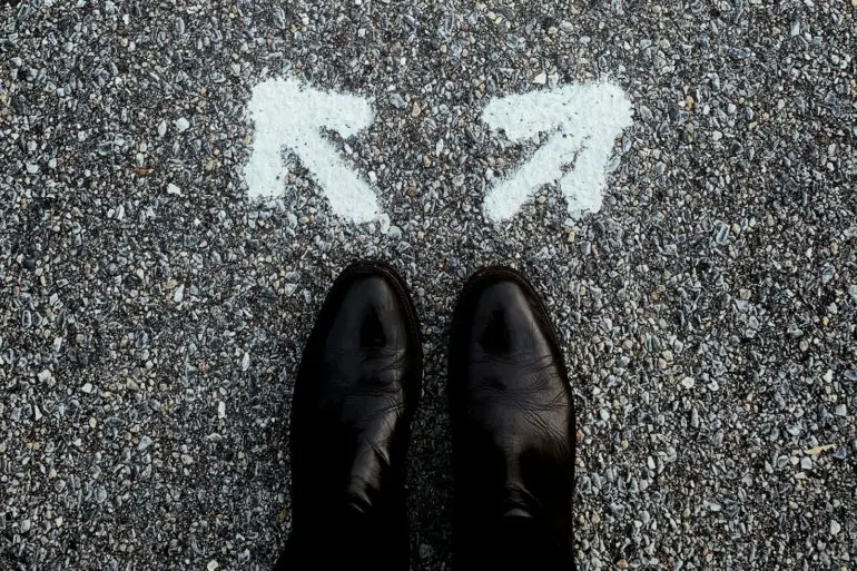 looking down at someone's shoes and with arrows pointing out in opposite directions