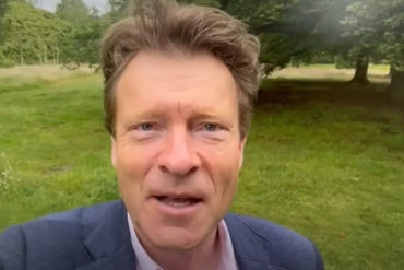 richard tice talking outdoors with greenery in the background