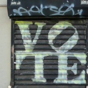 vote graffiti sprayed on shutters by vige